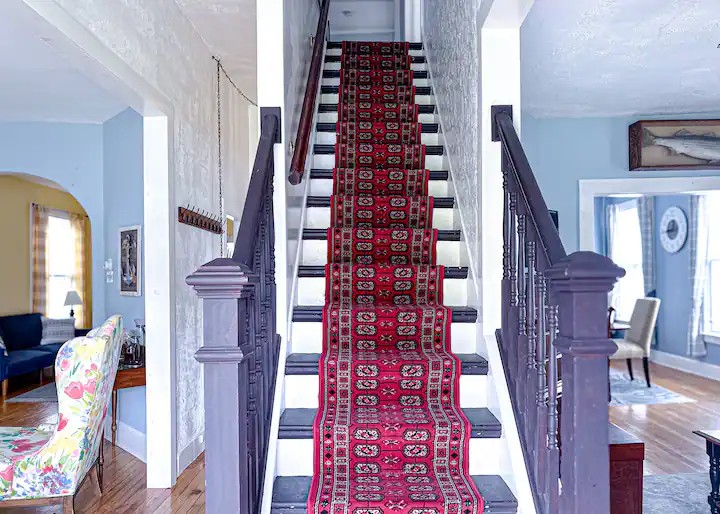 Historic staircase with red carpet runner