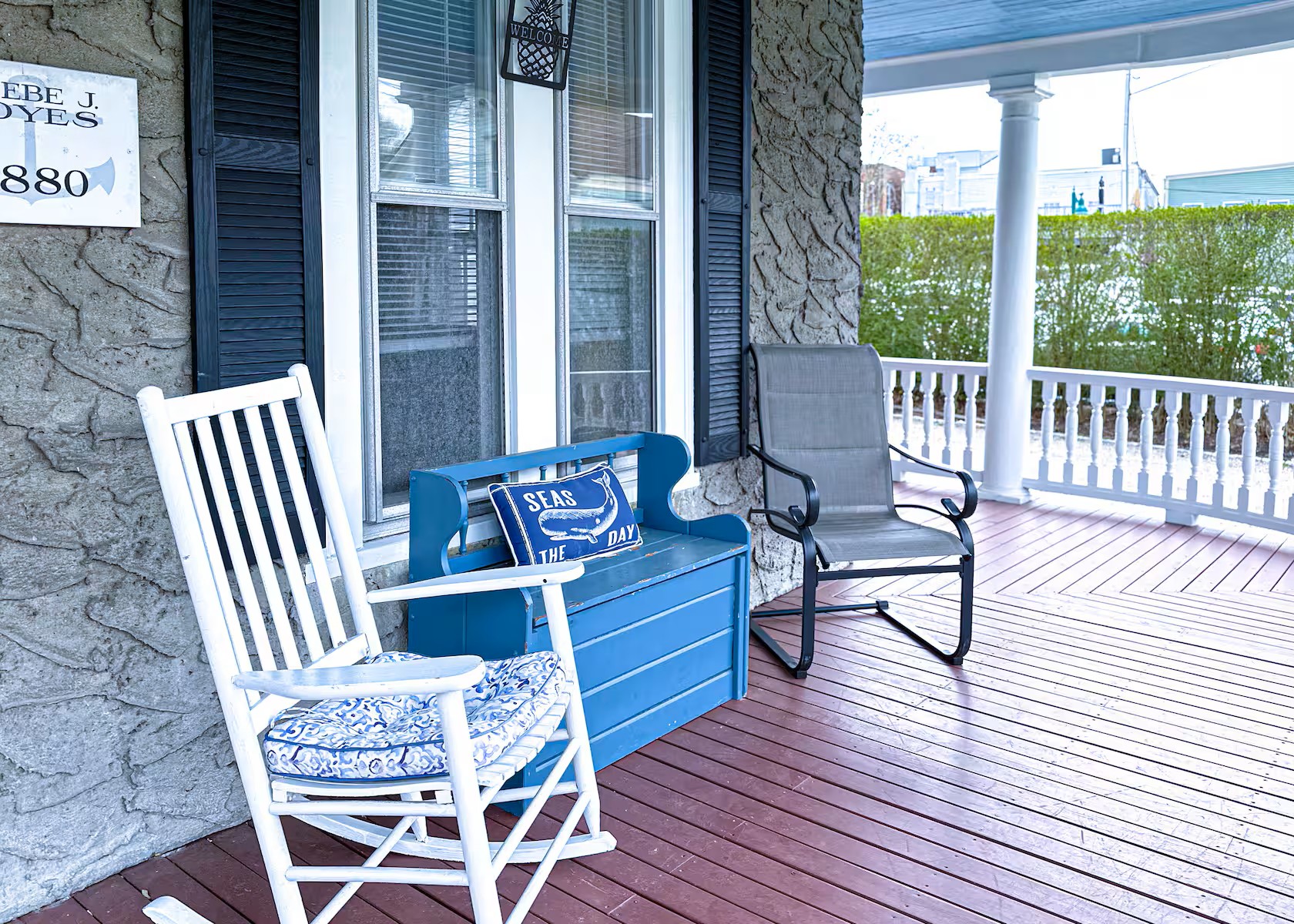 Wrap-around front porch with lawn chairs